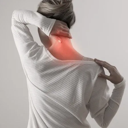 A person touching the back of the neck, which is highlighted in red to represent pain or tension.